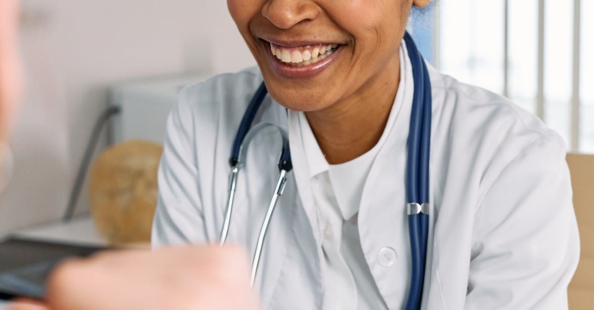 A female doctor is smiling while talking to a patient.