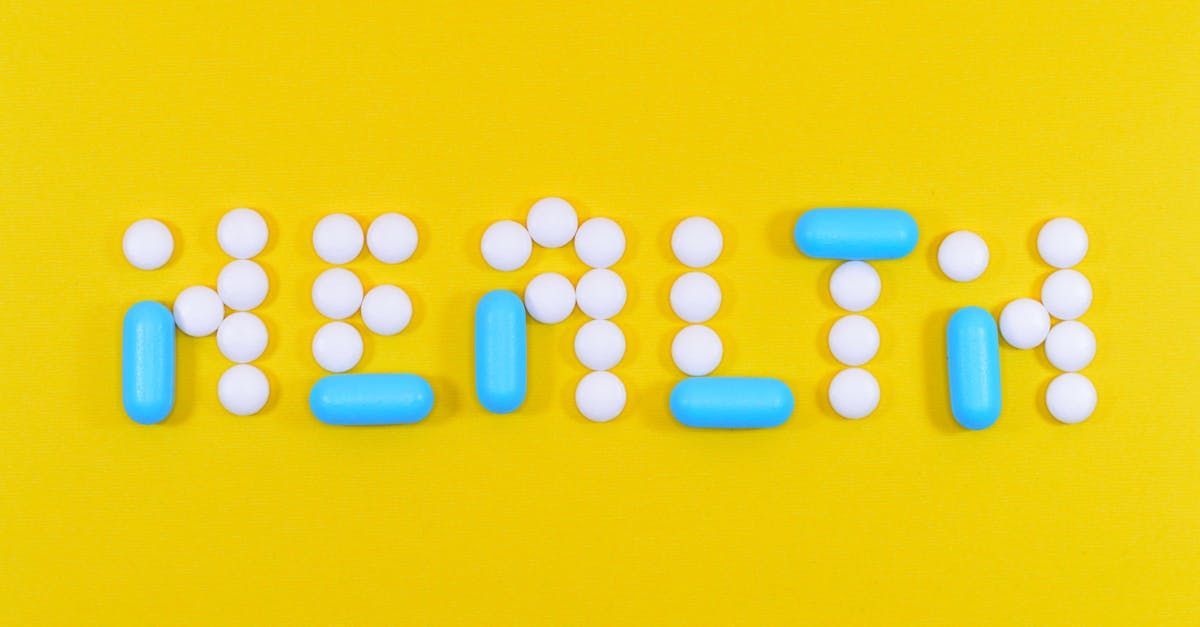 The word health is written with pills on a yellow background.