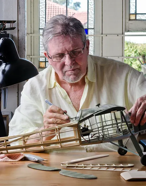 Old man making a model plane