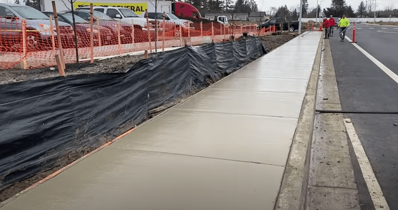 Concrete contractor installs a sidewalk for a local business development in Irvine, CA