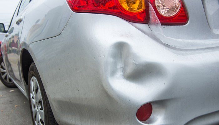 Dent Removal — Gray Car With Bump in Sandy, UT
