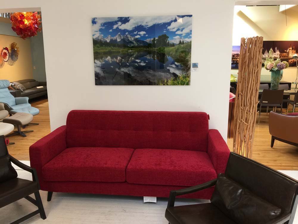 red couch with picture of mountains above it