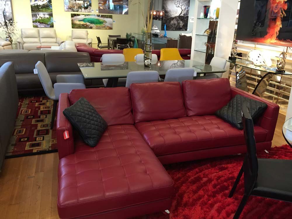 red leather couch with black pillows