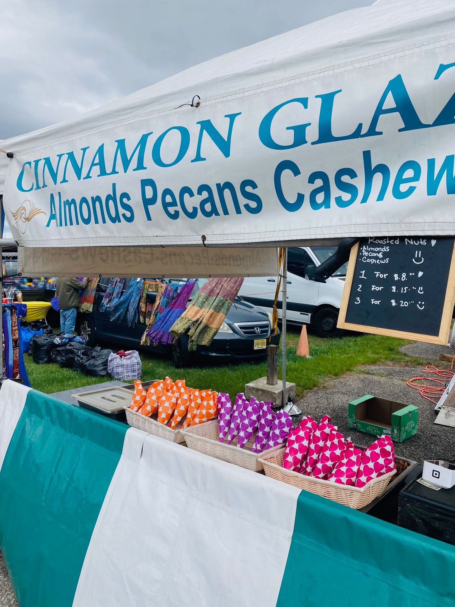 A table with a sign that says cinnamon glazed almonds pecans cashews