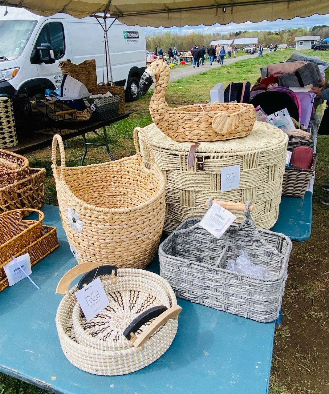 A bunch of baskets are sitting on a table under a tent.