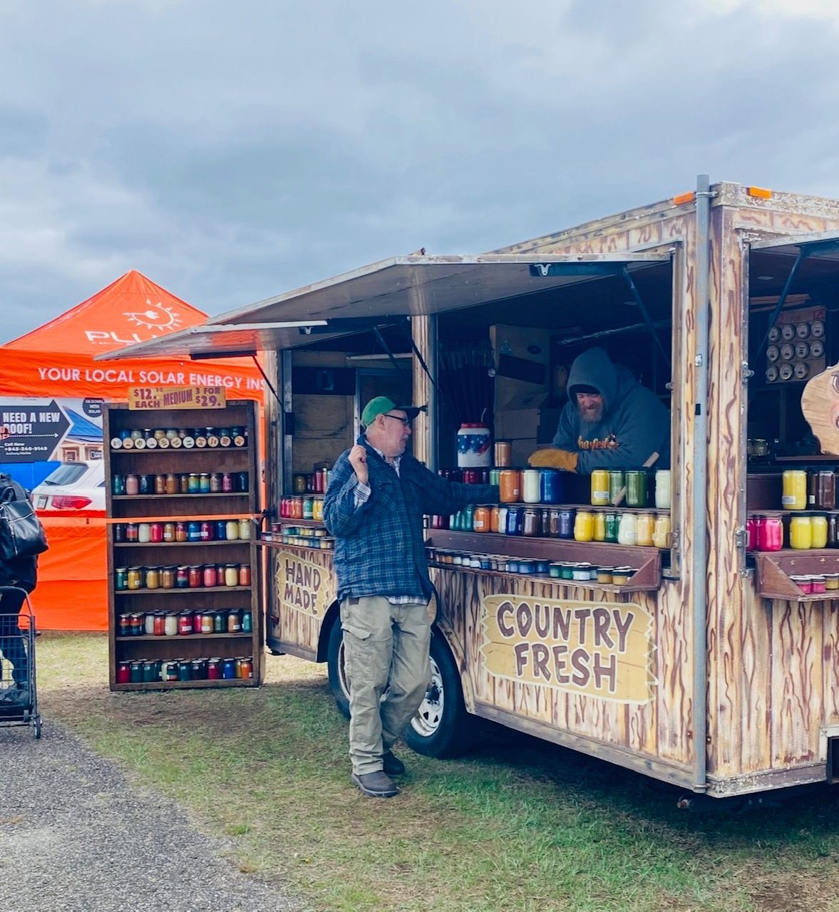 A man standing in front of a country fresh food truck