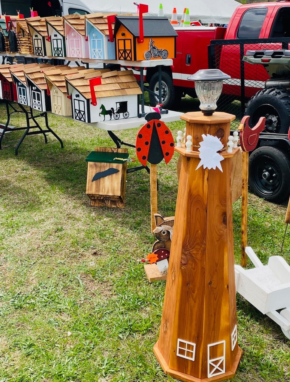 A wooden mailbox with a ladybug on top of it