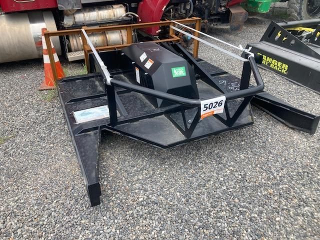 Black brush cutter machine on gravel.