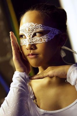 A woman is wearing a white mask on her face.