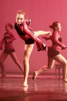 A group of young women are dancing on a stage.