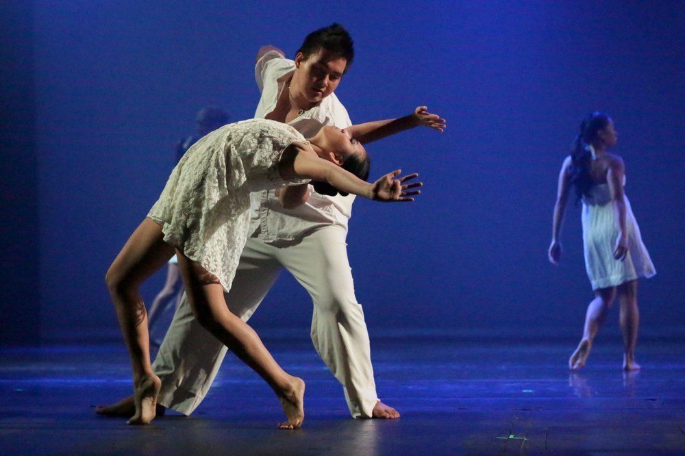 A man and a woman are dancing on a stage.