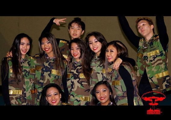 A group of people posing for a picture wearing camo shirts