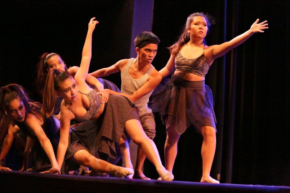 A group of young people are dancing on a stage.