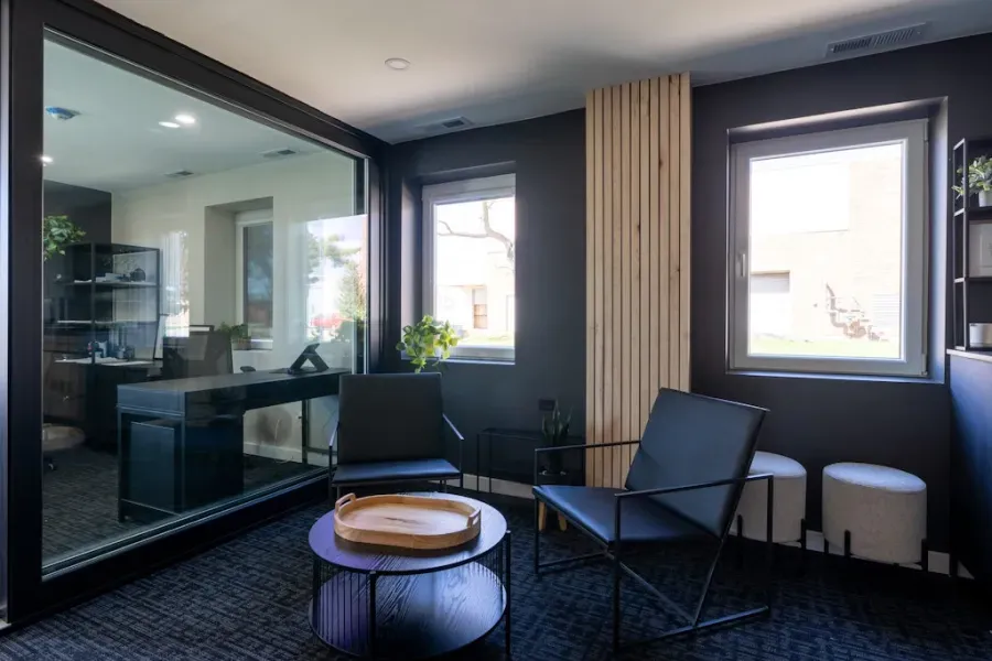 There are two chairs and a coffee table in the room.