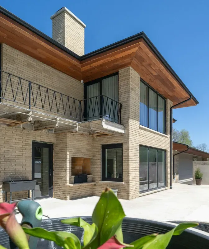 A large brick house with a balcony and lots of windows