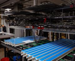 A warehouse filled with lots of blue and green pieces of metal