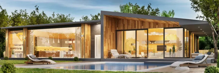 A modern house with a swimming pool in the backyard surrounded by trees.