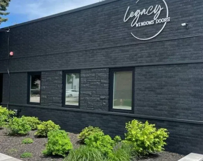 A black brick building with the word legacy on it