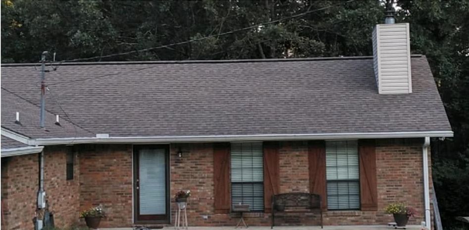 A brick house with a chimney on the roof