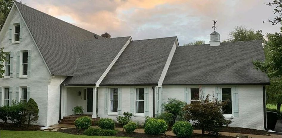 A large white house with a gray roof