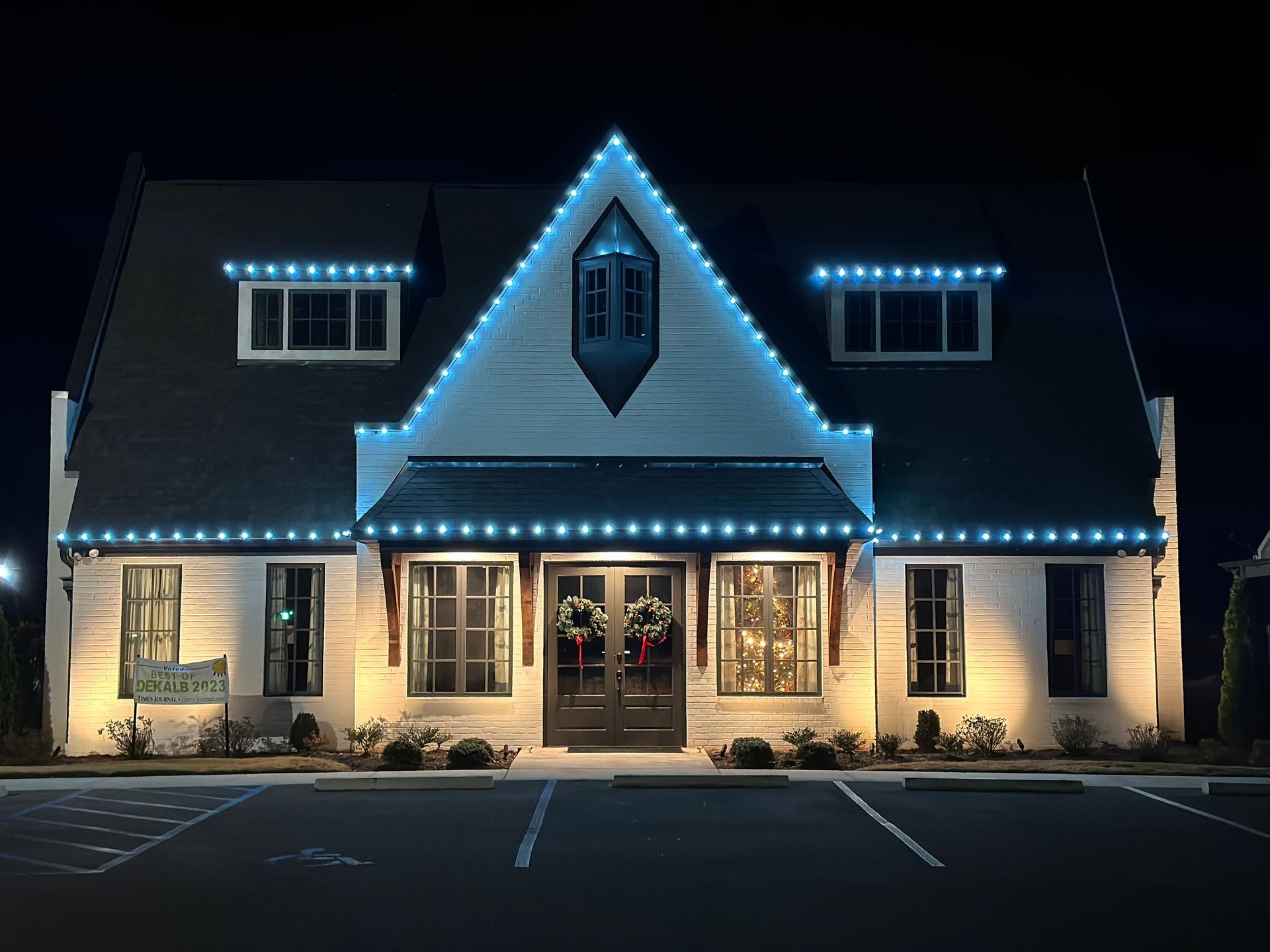 A large white house with blue lights on the roof