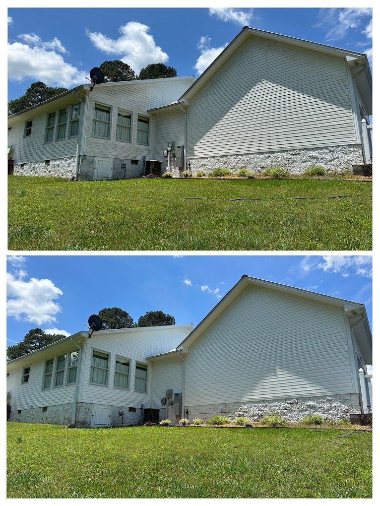 A white house with a gray roof and a porch.
