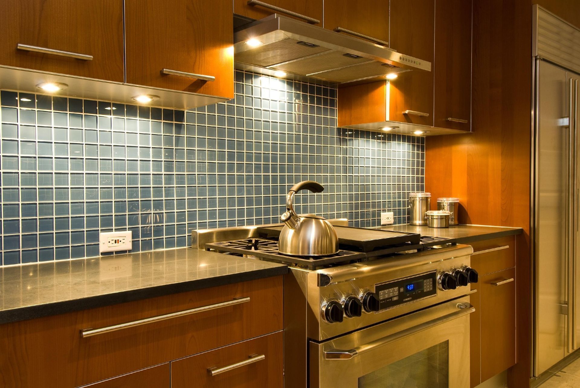 A kitchen with stainless steel appliances and wooden cabinets
