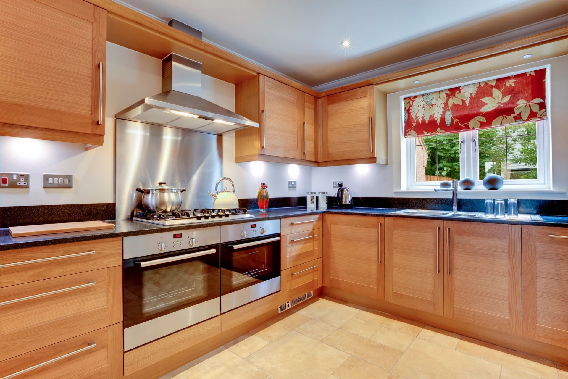 A kitchen with wooden cabinets and stainless steel appliances