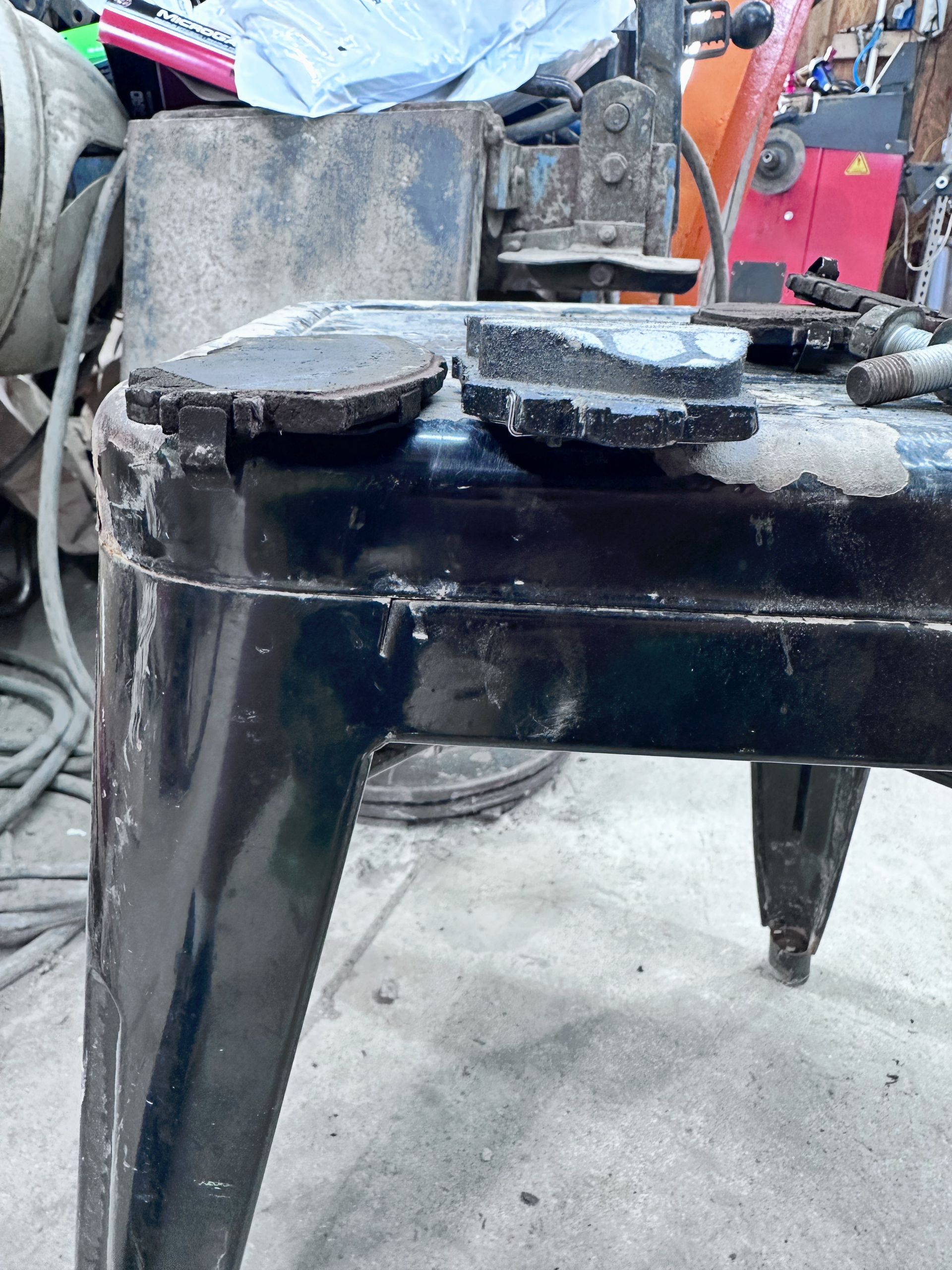 Black workbench with tools, dusty, in a workshop setting. | Midwest Tire & Service LLC