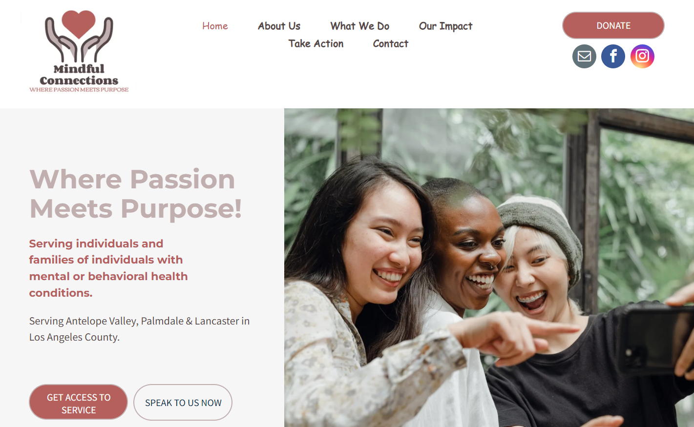 A group of people are taking a selfie on a cell phone.