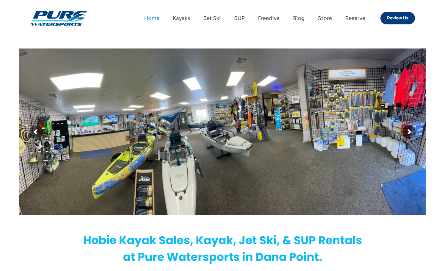 A website for pure watersports shows a store filled with kayaks and jet skis.