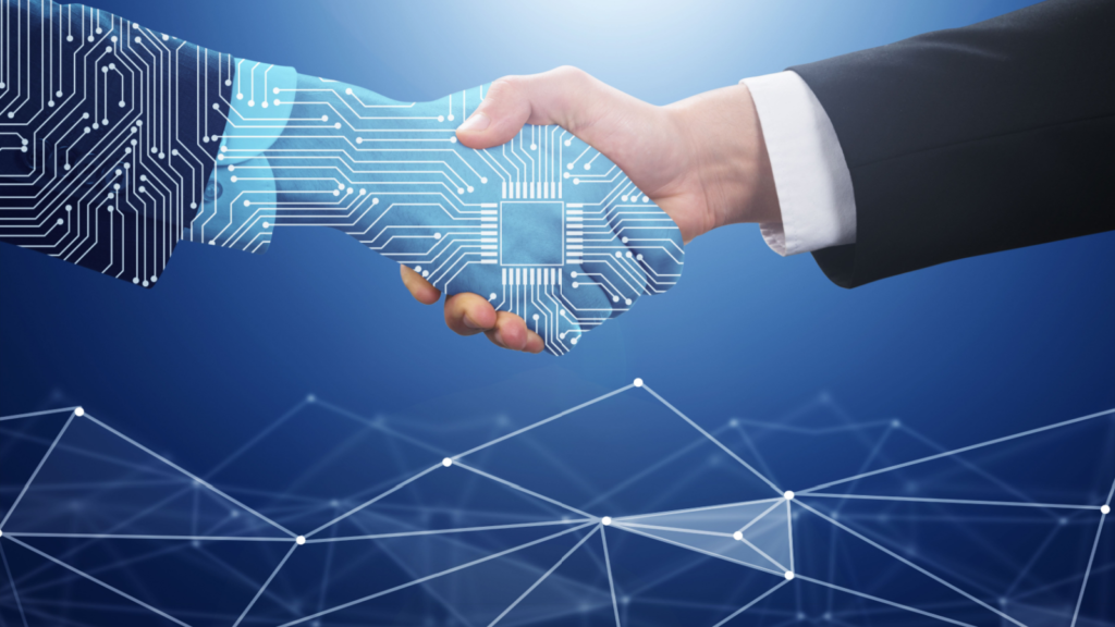 A man and a robot are shaking hands with a circuit board in the background.