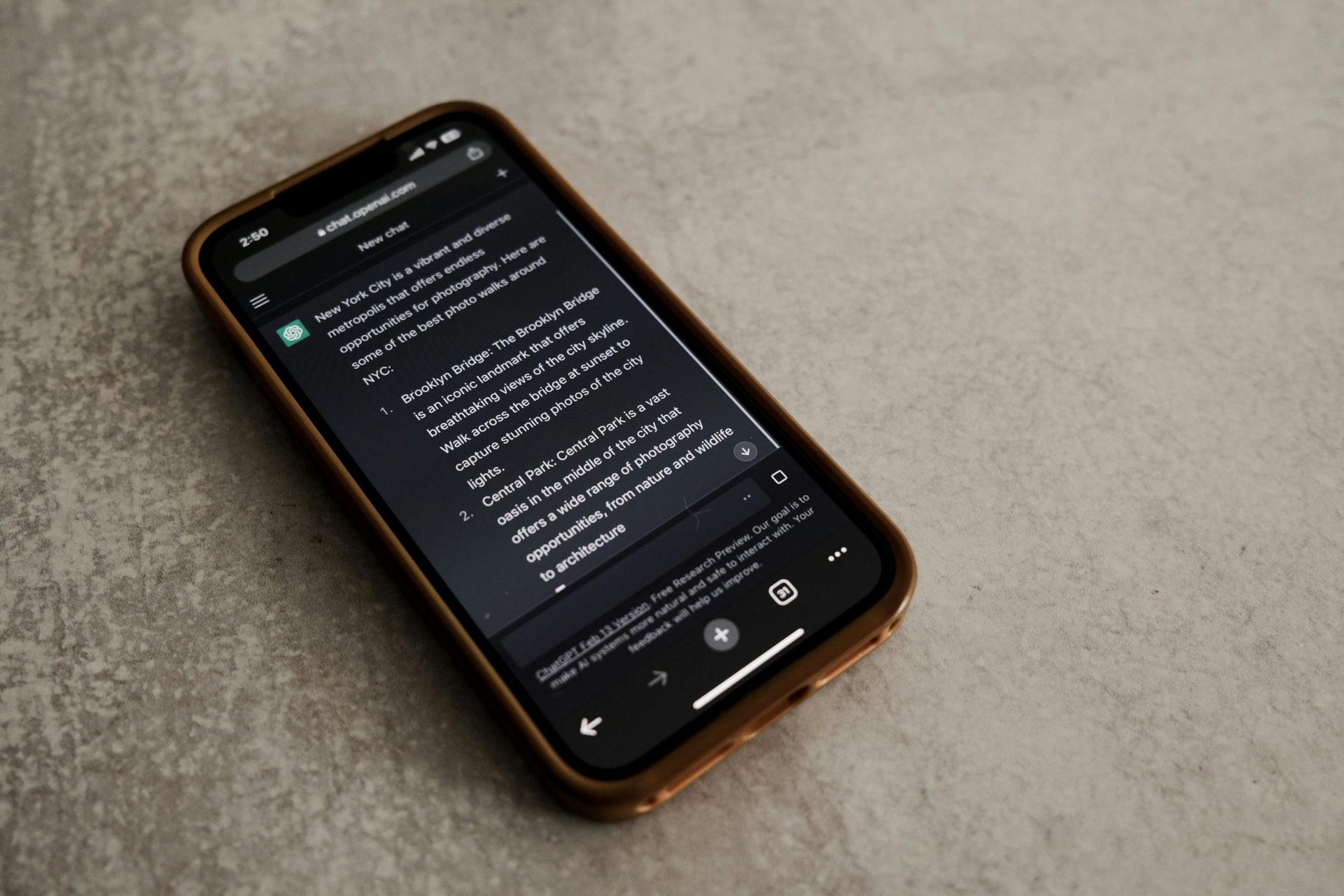 A cell phone with a dark screen is sitting on a table.