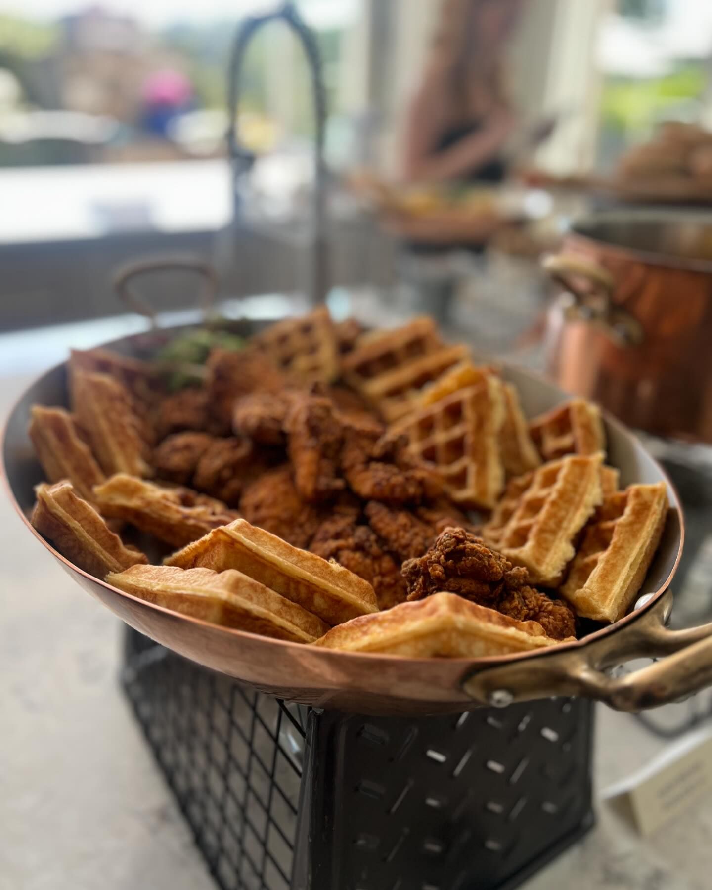 Chicken and waffles served on a copper platter, atop a wire stand, at a corporate  catered breakfast in Maryland 