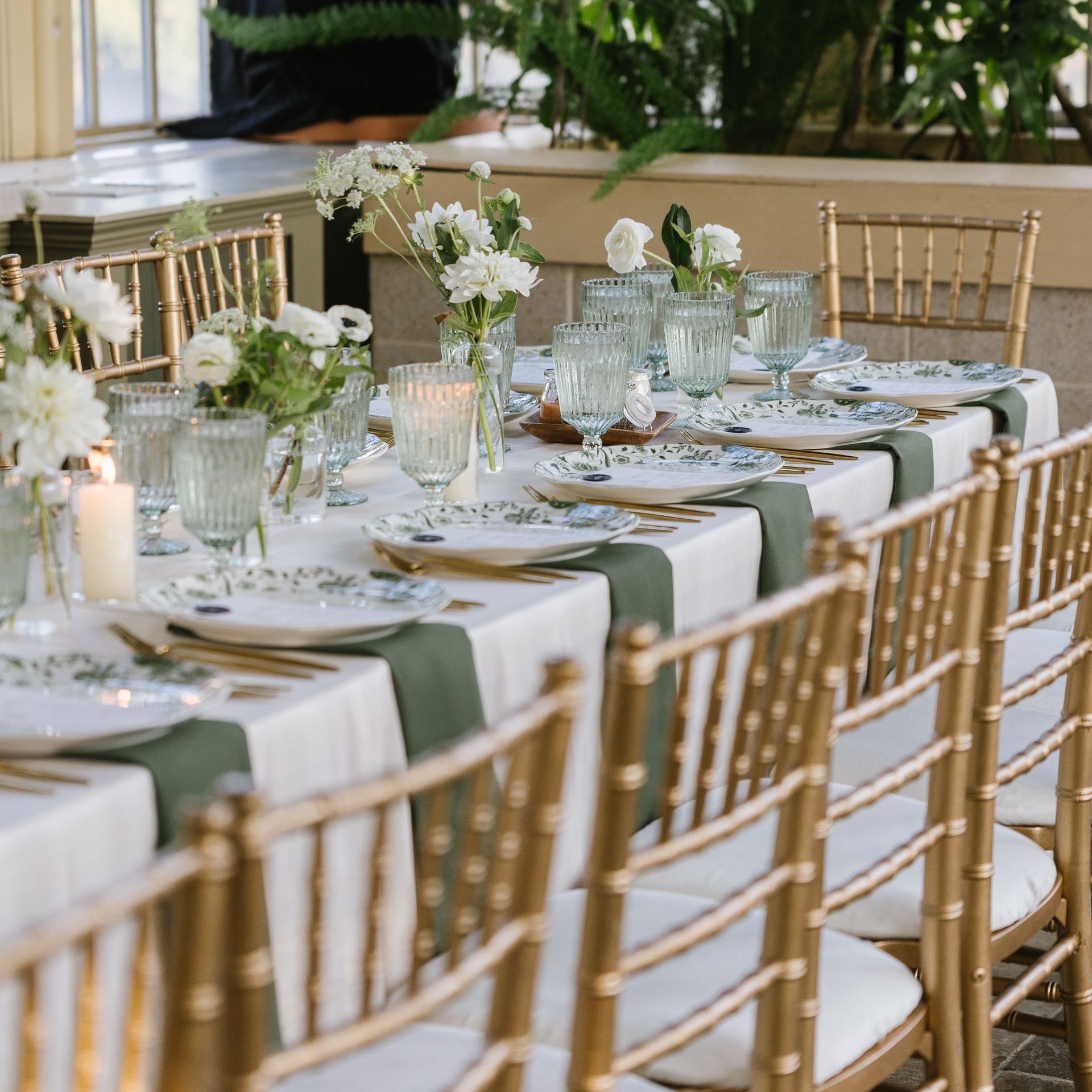 A long table with plates glasses and candles on it set by Wedding Caterer in Baltimore, Maryland