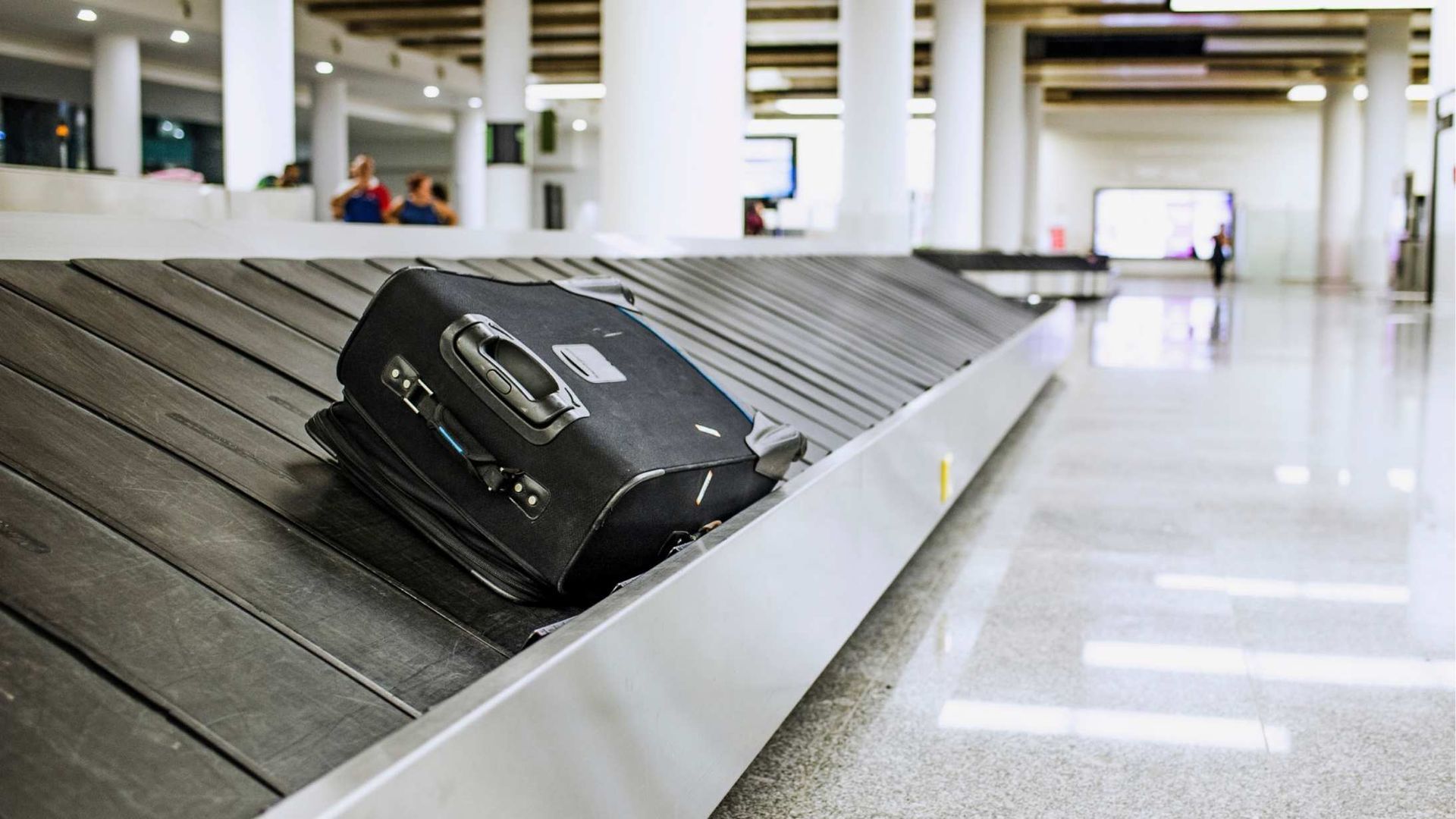 Modern two-story office building with large glass windows and blue sky.