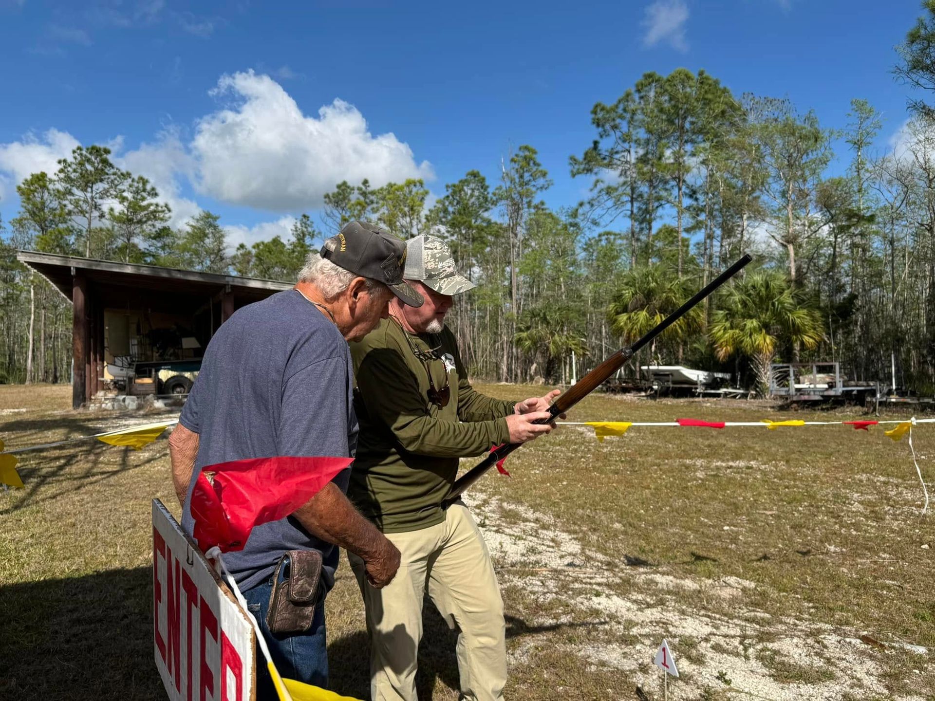 2 men looking at a gun