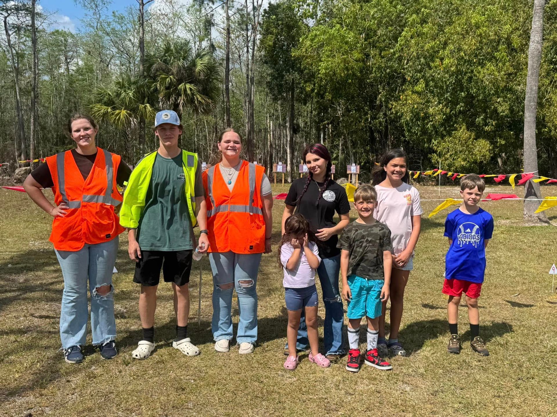 A group of people standing next to each other in a field.