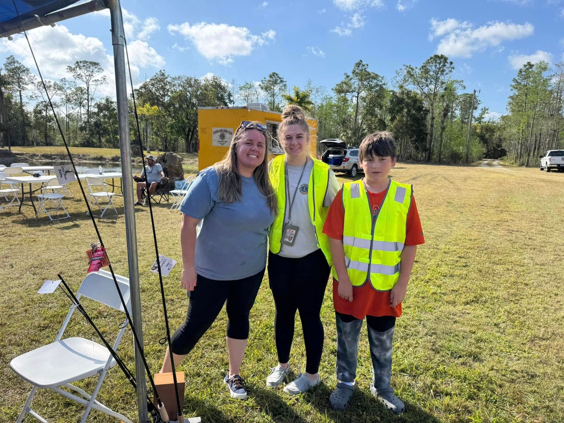 A group of people are posing for a picture in a field.