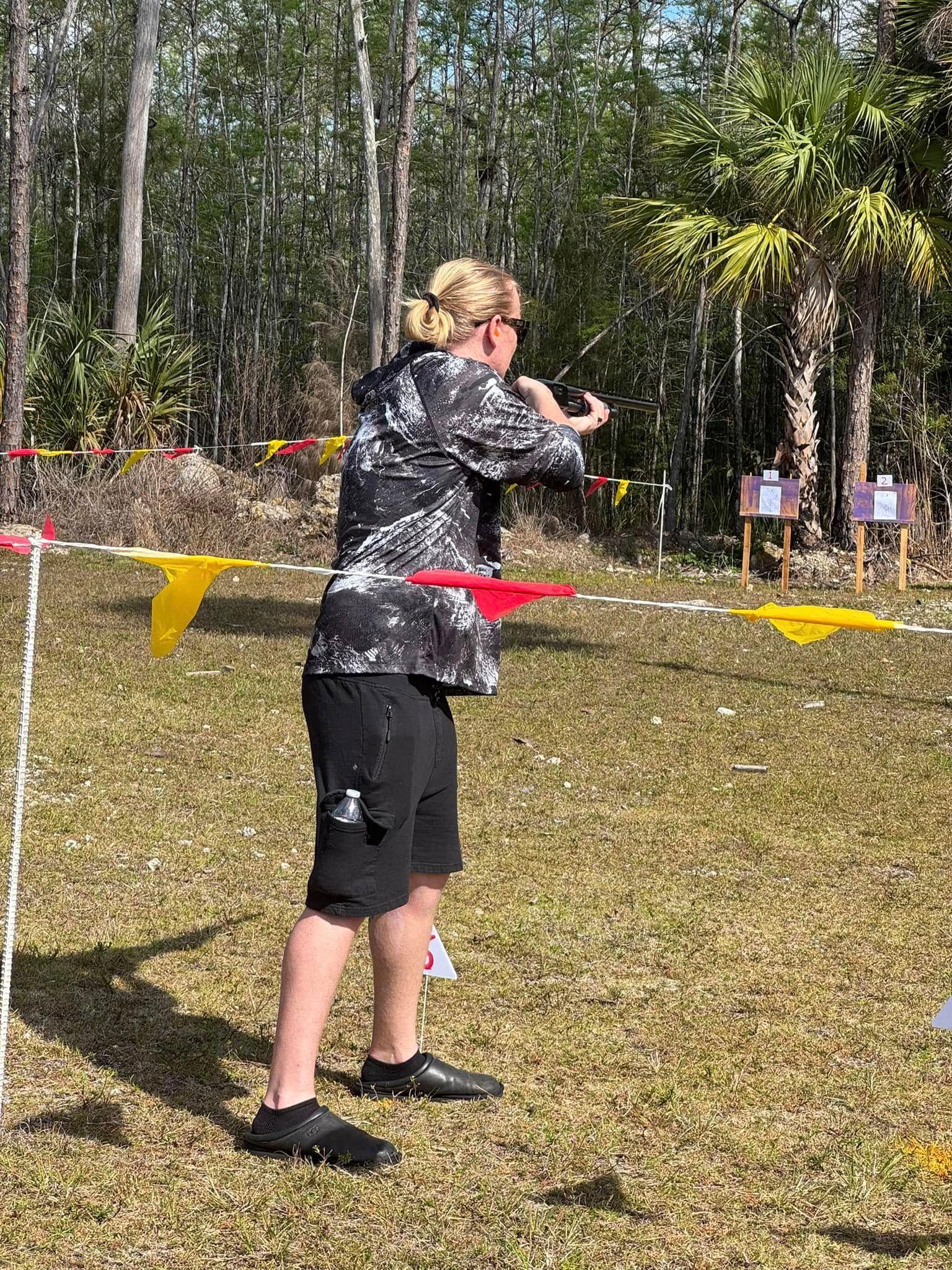 A woman is throwing a frisbee in a field.