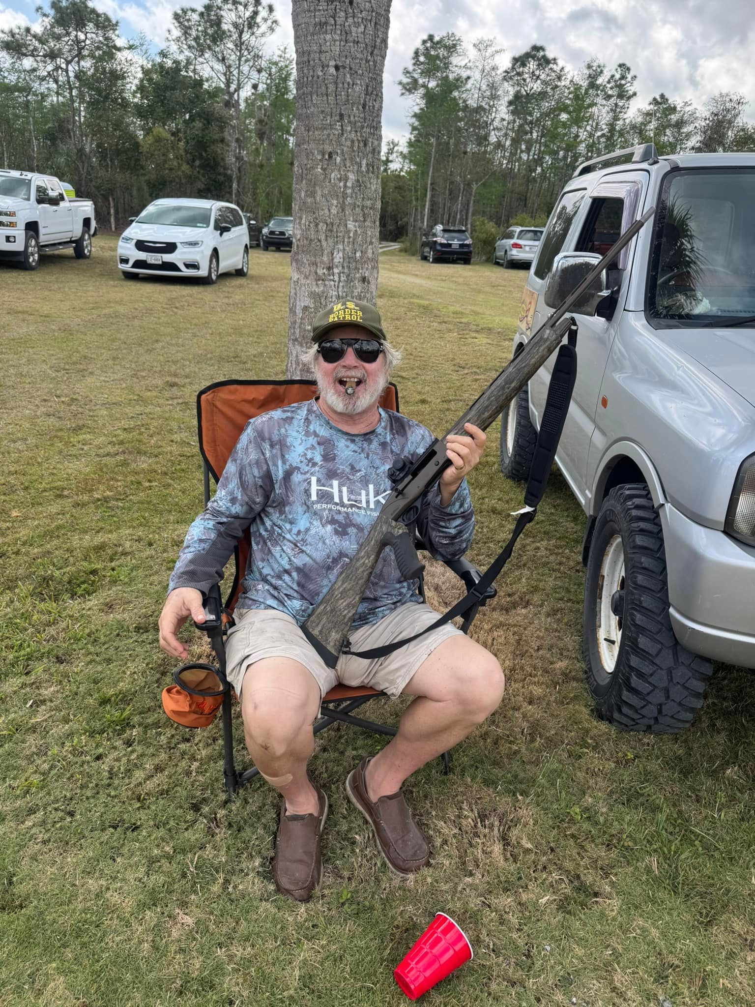 man in a chair holding a gun