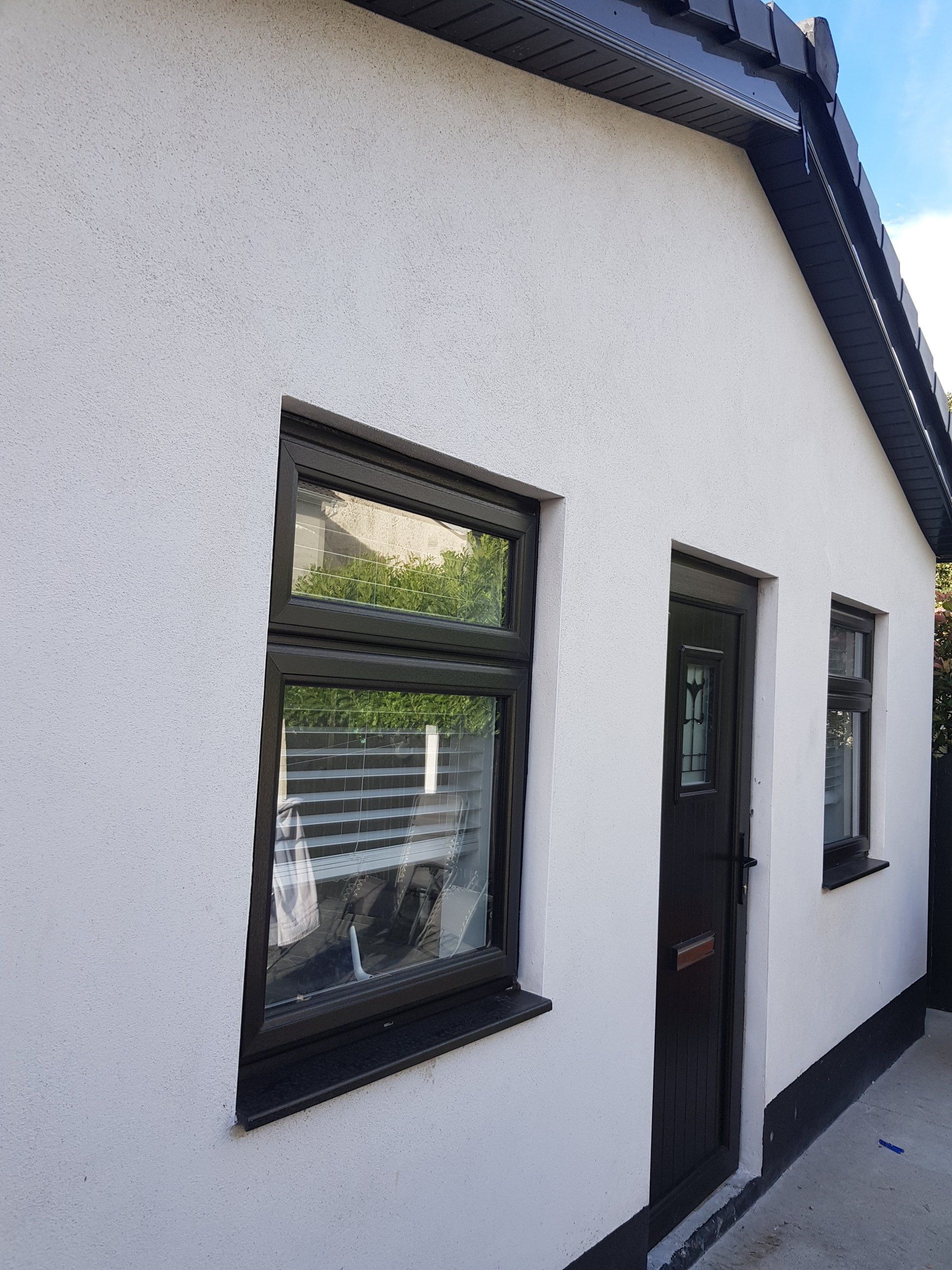 A white house with black windows and a black door