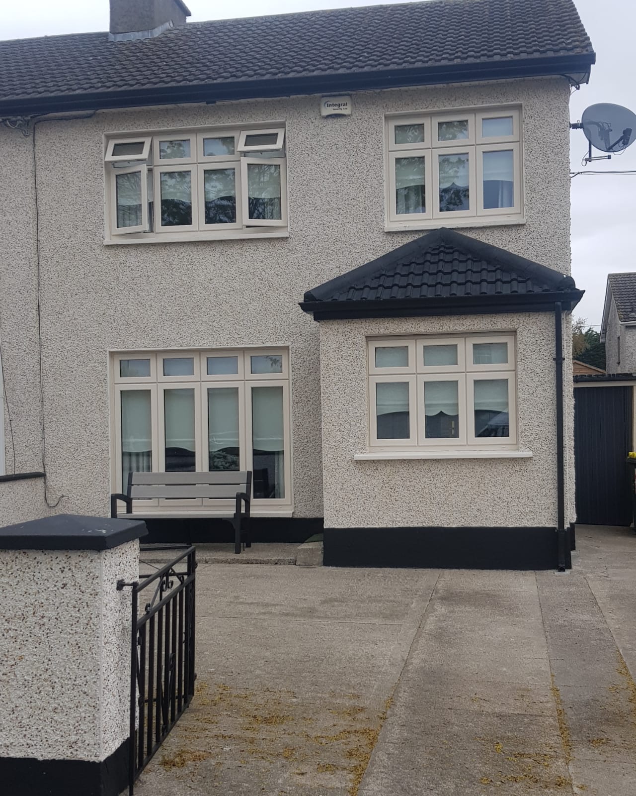 A white house with a black roof and white windows