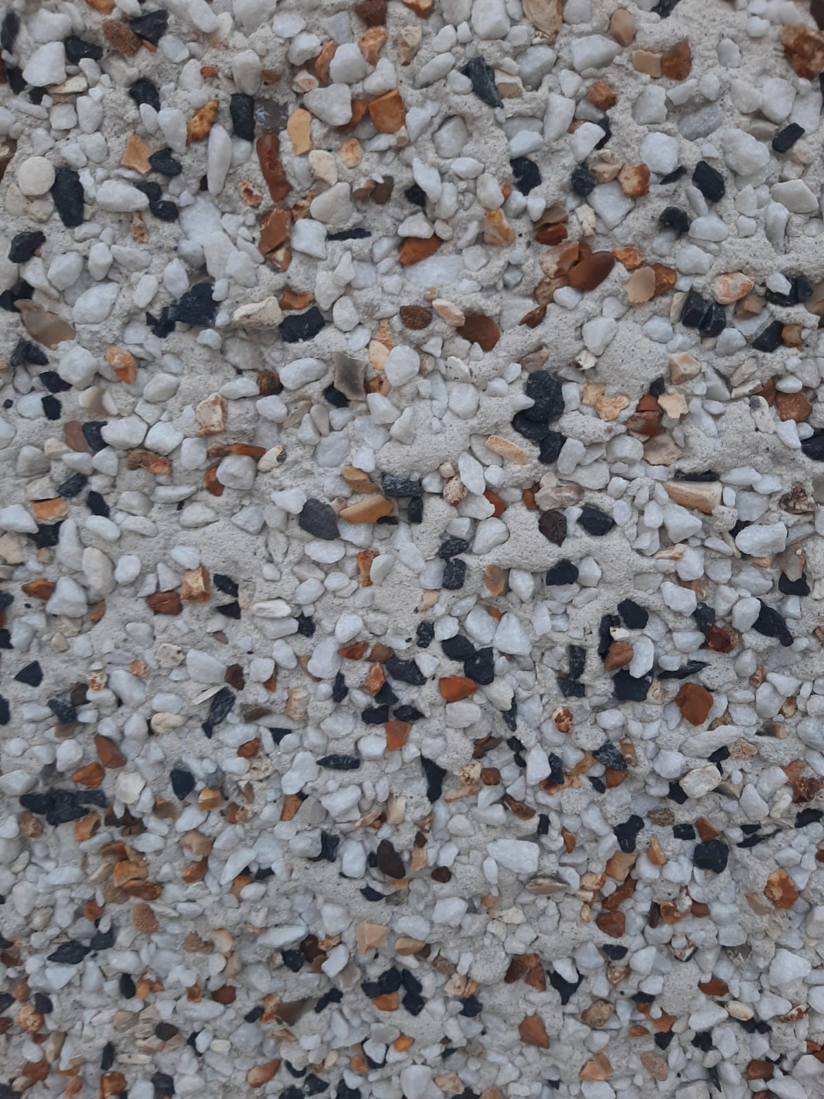 A close up of a pile of small rocks on a wall