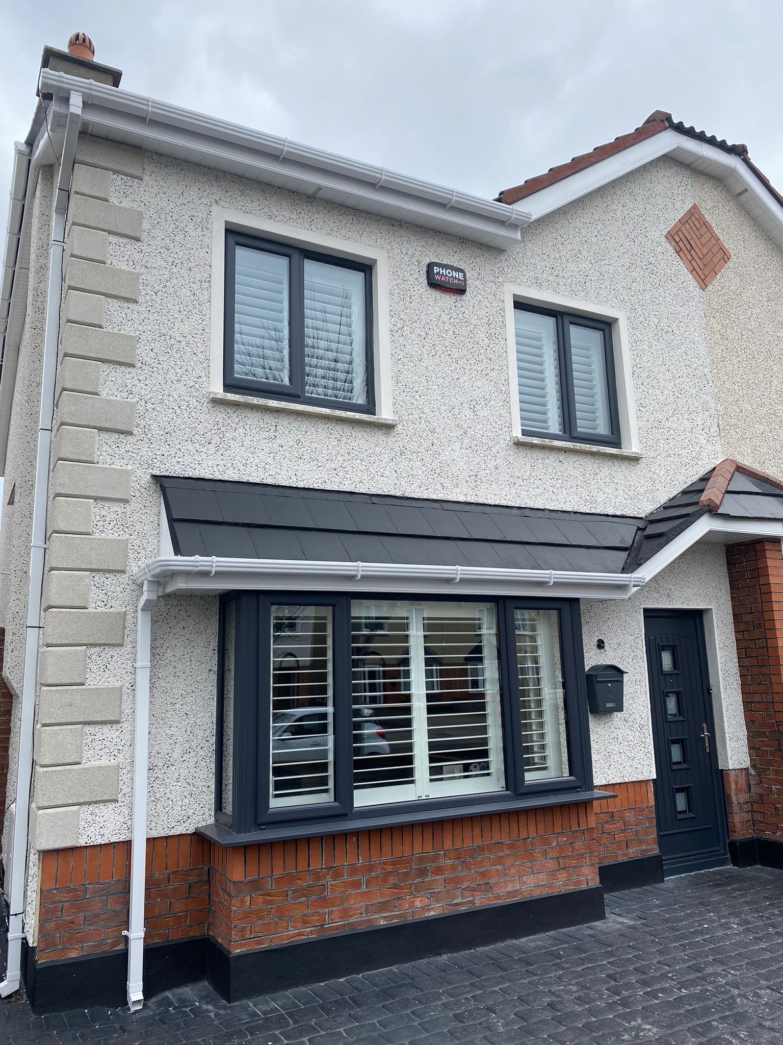 A white house with black windows and a black door.