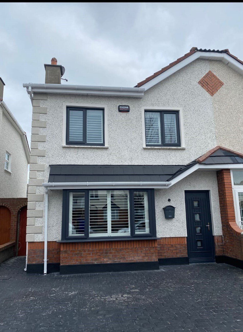 A house with a lot of windows and a black door