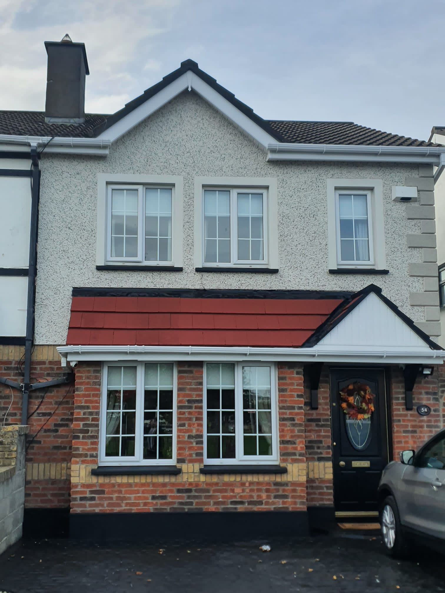 A house with a car parked in front of it