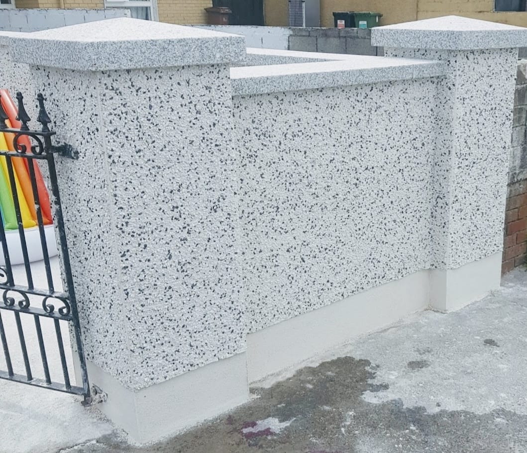 A stone wall with a gate in front of it.