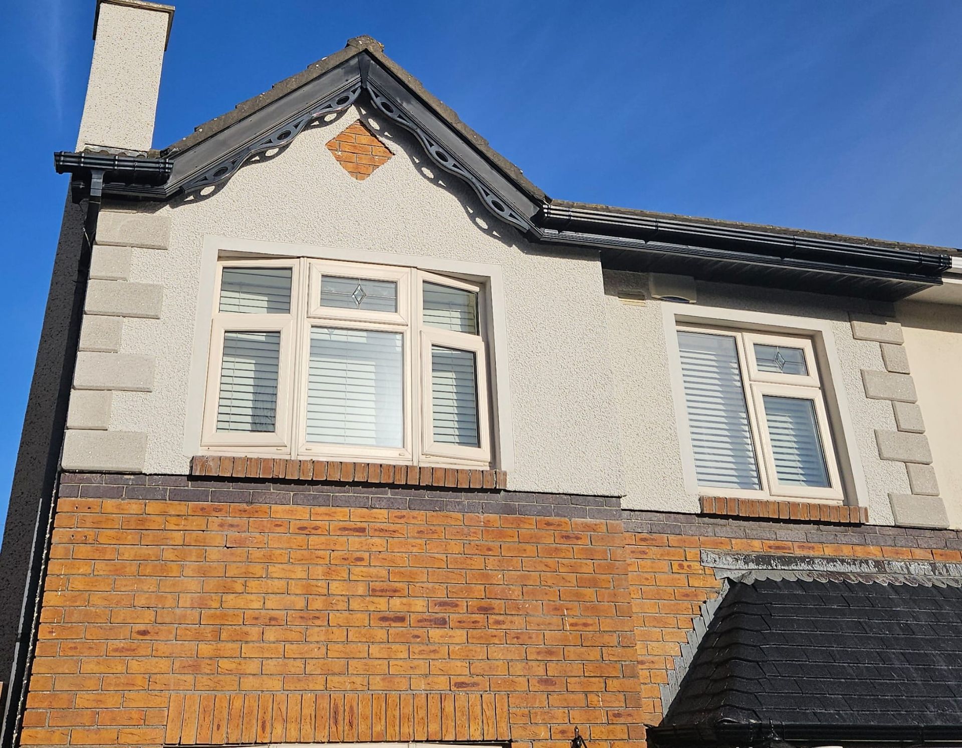A house with a brick wall and a white roof