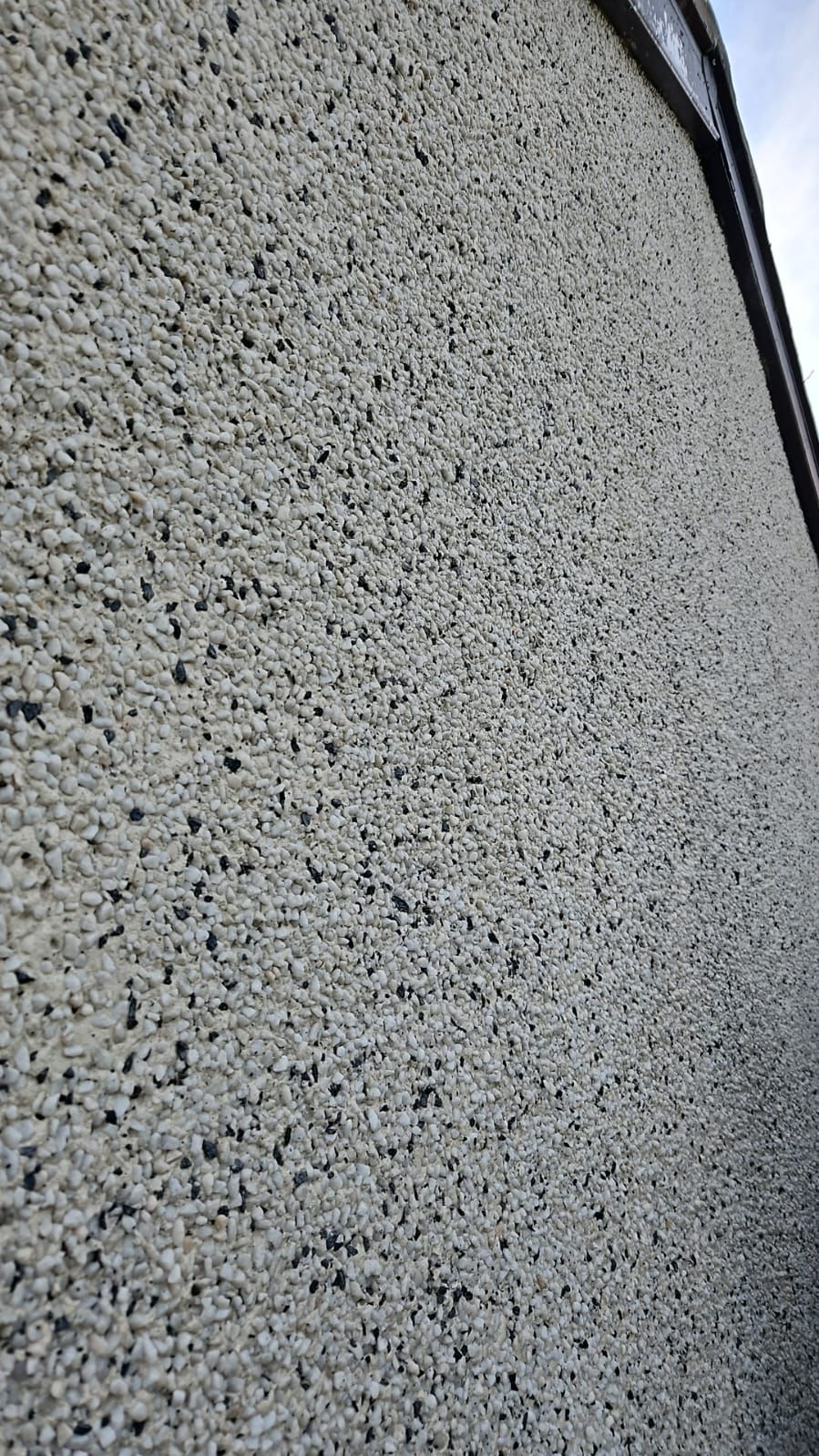 A close up of a wall with a lot of small stones on it.